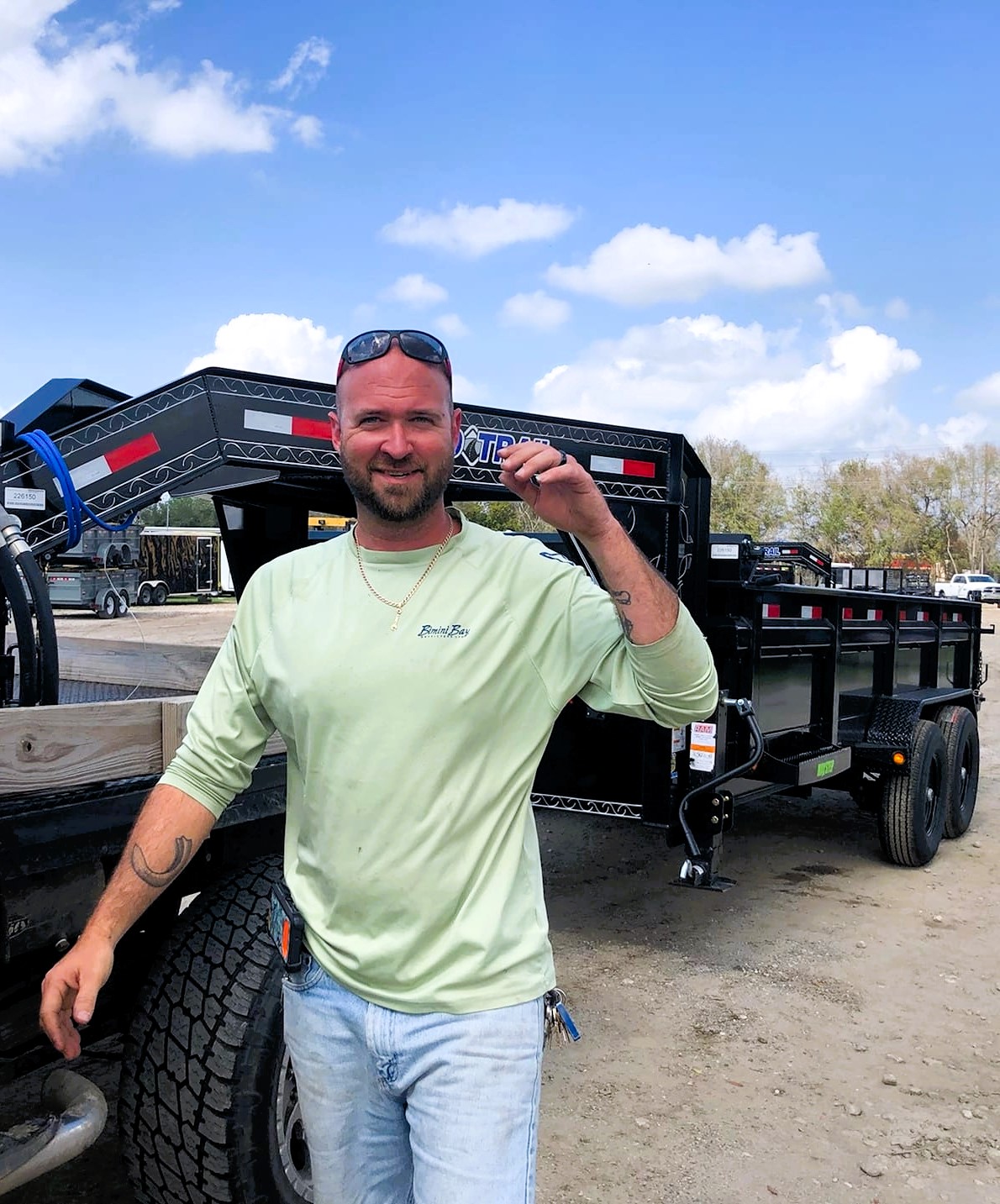 Dumpster trailer with M.L. Moody, Inc. team member